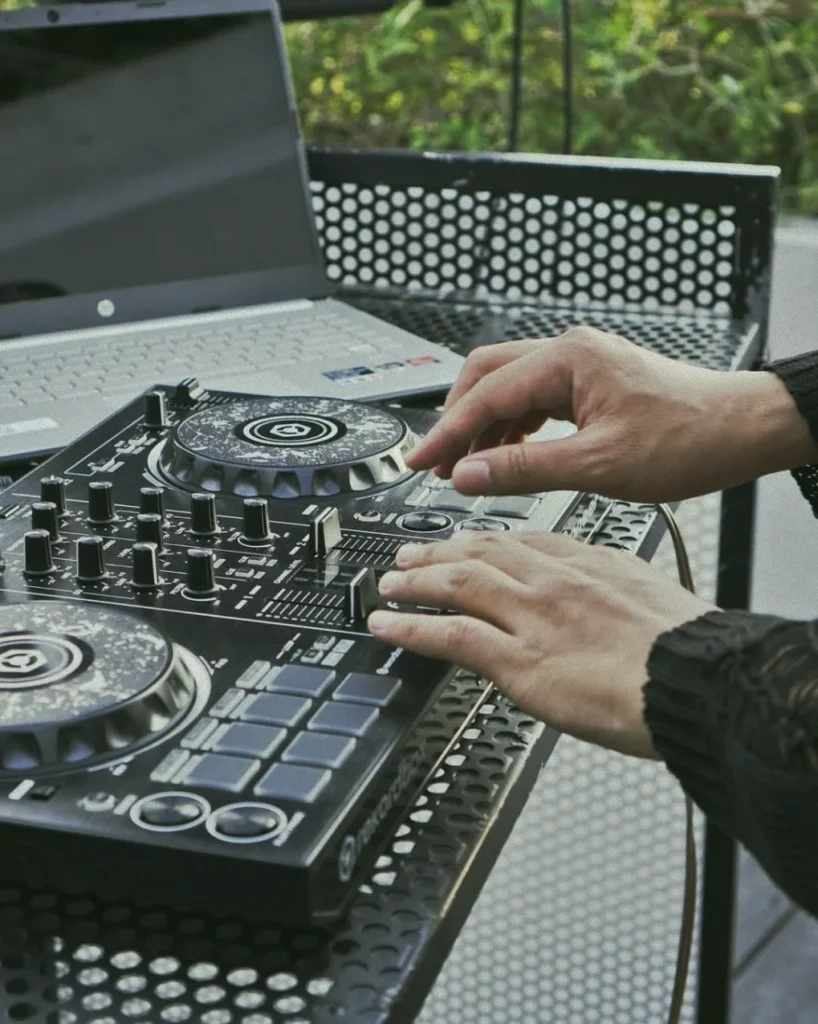 A DJ mixing music at an event at 06 in Canggu, Bali, creating a vibrant atmosphere for the community to enjoy.