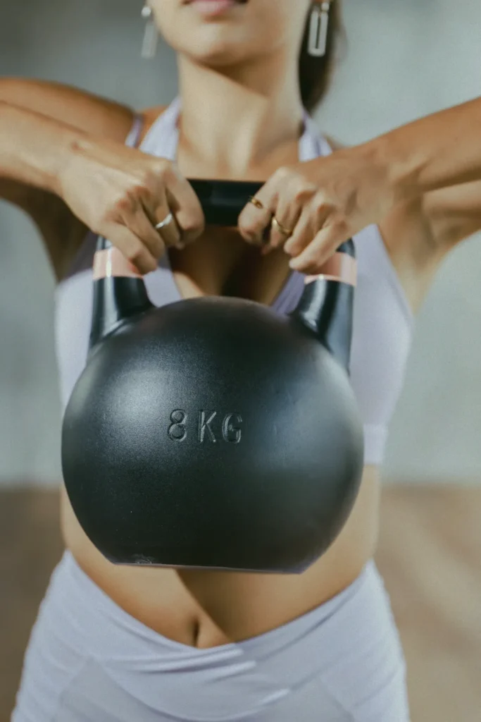 A woman working out at the at 06 gym in Canggu, holding an 8kg kettlebell, embodying the fitness and wellness lifestyle of this Bali hub.