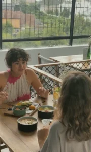 Best Coworking Space in Canggu Bali: AT 06 MBTI Guide 2025 3 Two friends sharing a healthy meal and deep conversation at the at 06 fusion restaurant in Canggu, Bali, fostering a sense of community.