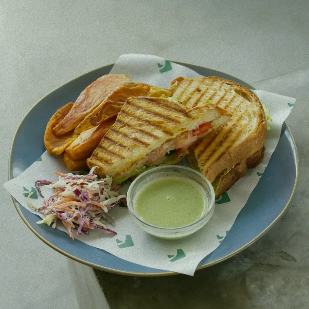 A close-up of a delicious smoked salmon panini from the at 06 restaurant in Canggu, showcasing the healthy and tasty European-Asian fusion cuisine available at this Bali dining spot.