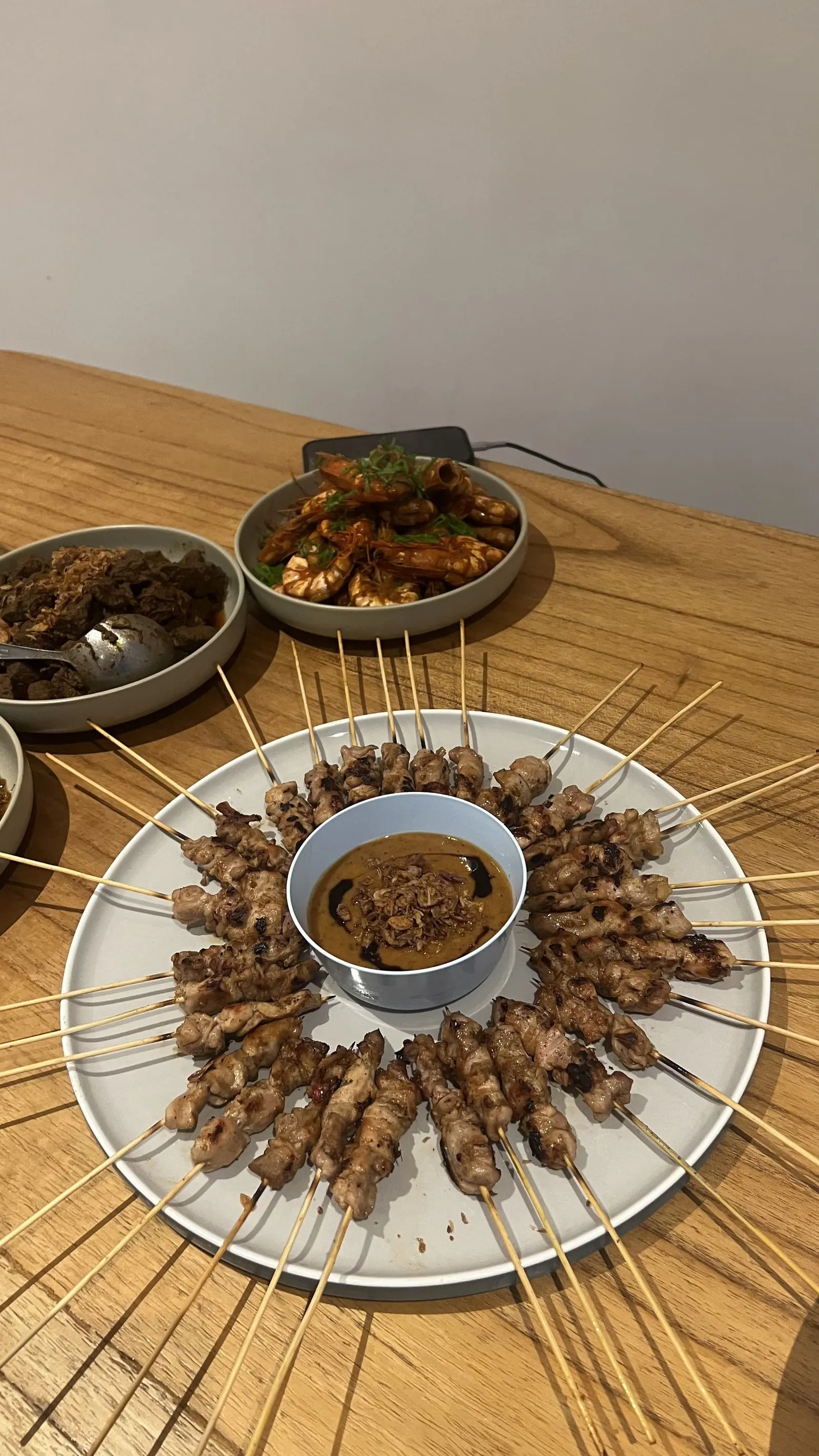 A platter of chicken satay with peanut sauce, a popular dish at AT06 restaurant in Canggu.