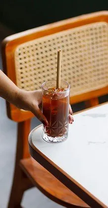 A glass of iced coffee on a table at AT06, a cafe in Canggu.