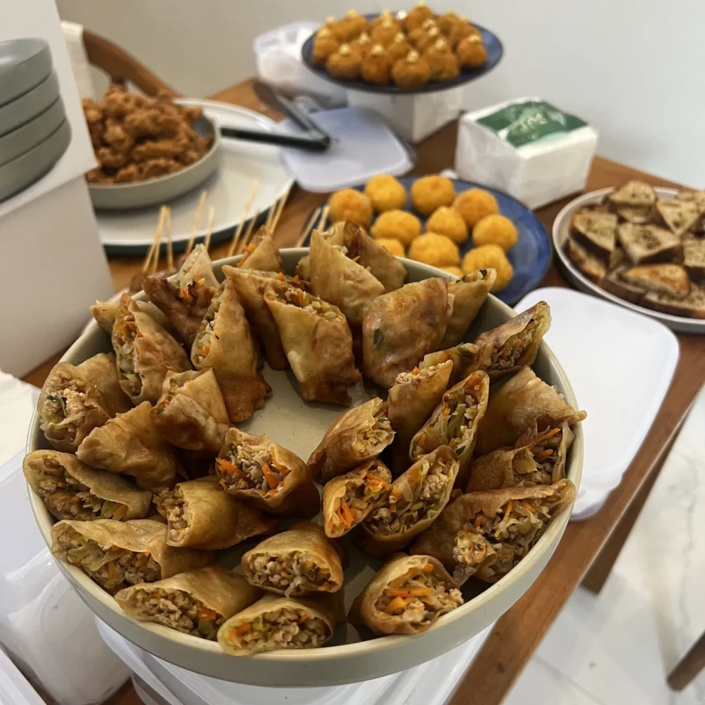 A variety of delicious finger foods, including spring rolls, served at an event at AT06 in Canggu.