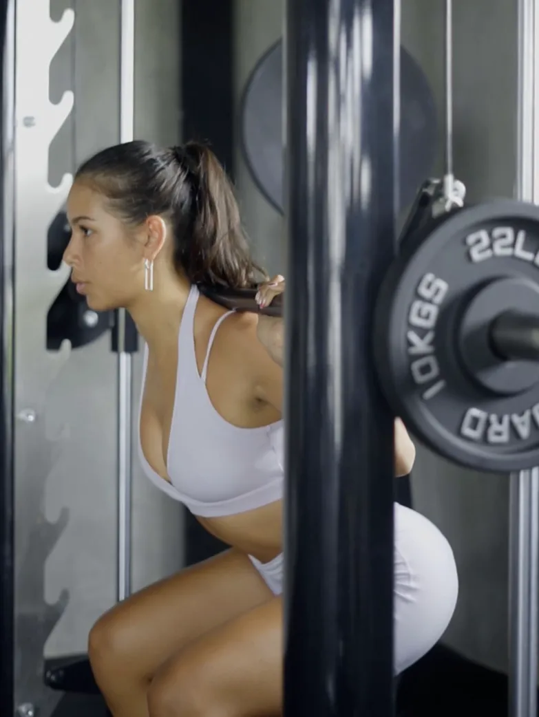 Video thumbnail of a woman doing squats with a barbell at the at06 gym.