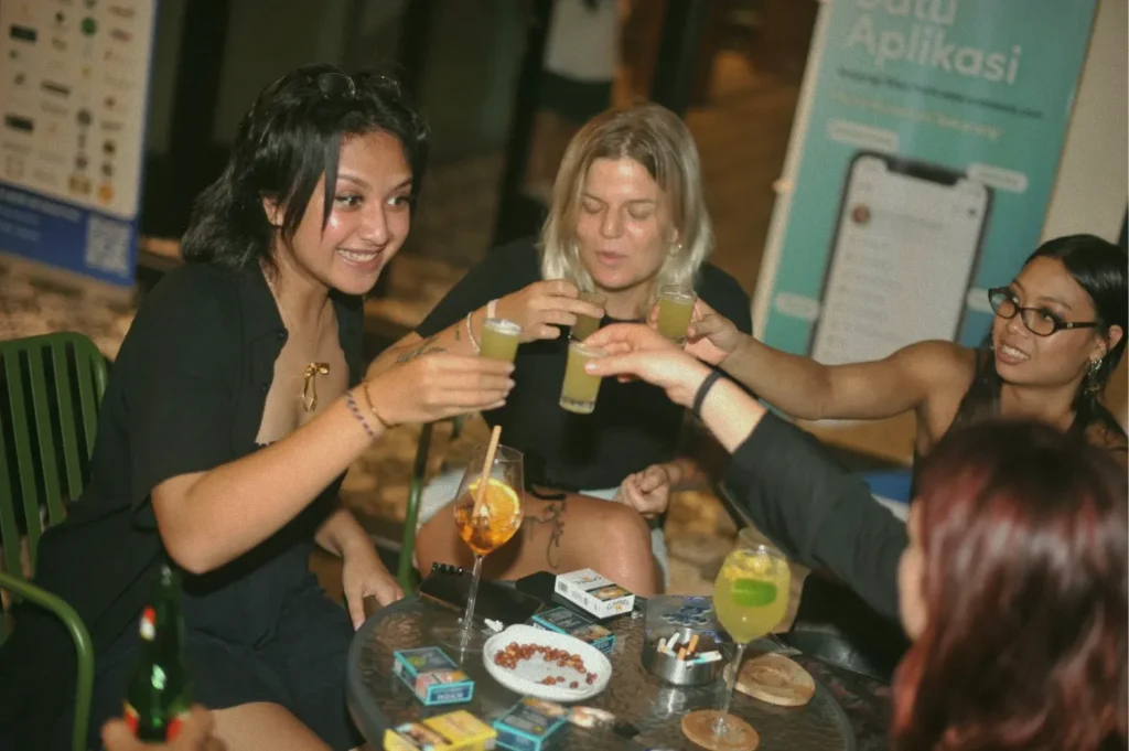 Women toasting with shots at AT 06, a multi-concept space in Canggu, Bali.