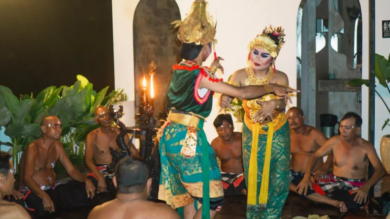 A traditional Balinese Kecak dance performance with costumed dancers and a chorus of men at at06 in Canggu.